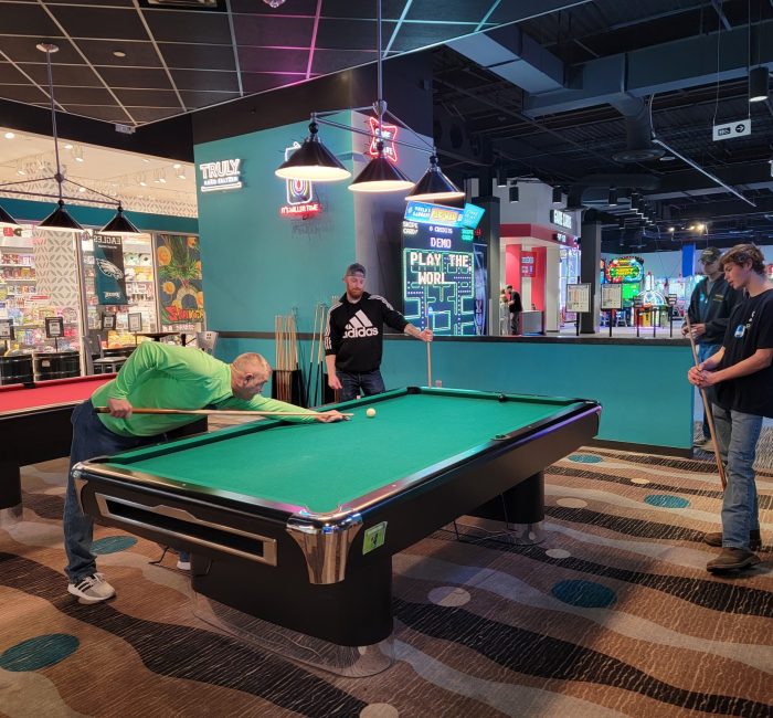 Bauer employees playing pool