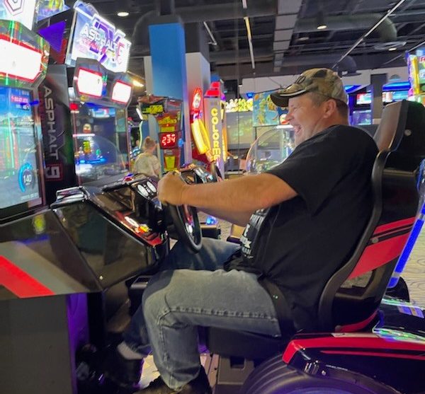 An employee playing a video game at a staff event