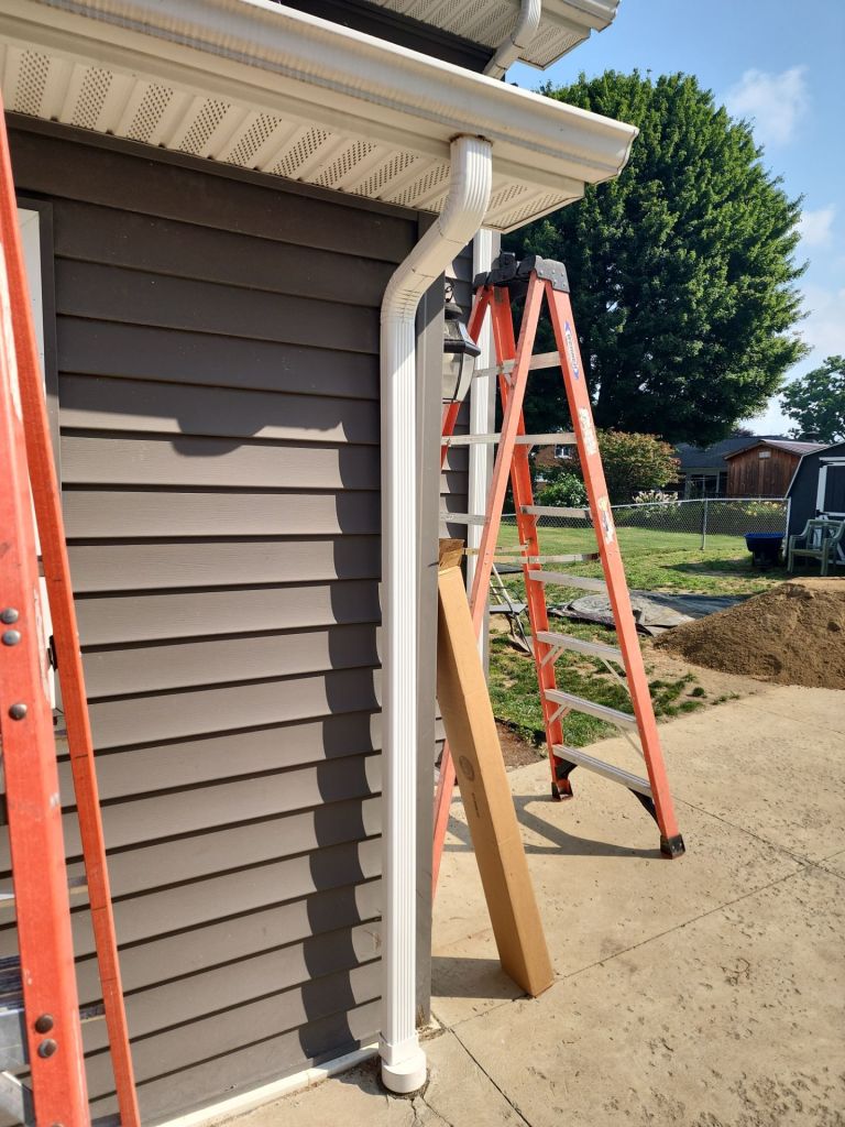White gutter with orange ladder