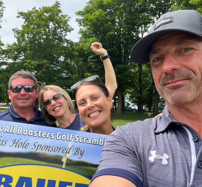 Bauer employees at golf tournament taking selfie