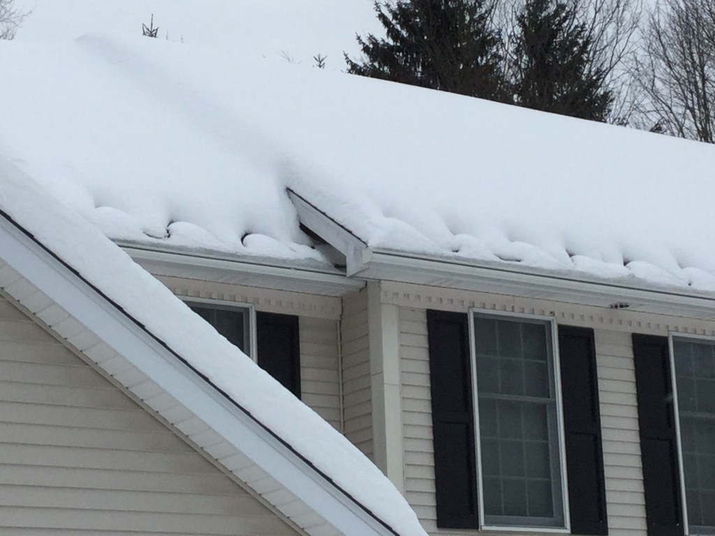 Heat Cables on a roof full of snow. Making sure that there aren't large icicles damaging your gutter's 