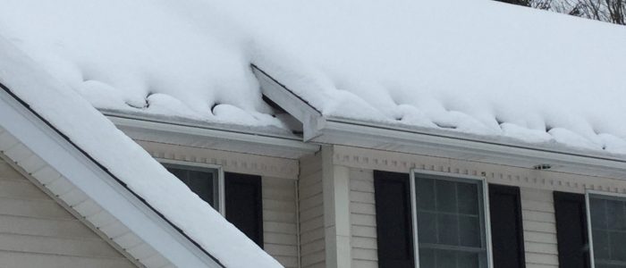 Heat Cables on a roof full of snow. Making sure that there aren't large icicles damaging your gutter's