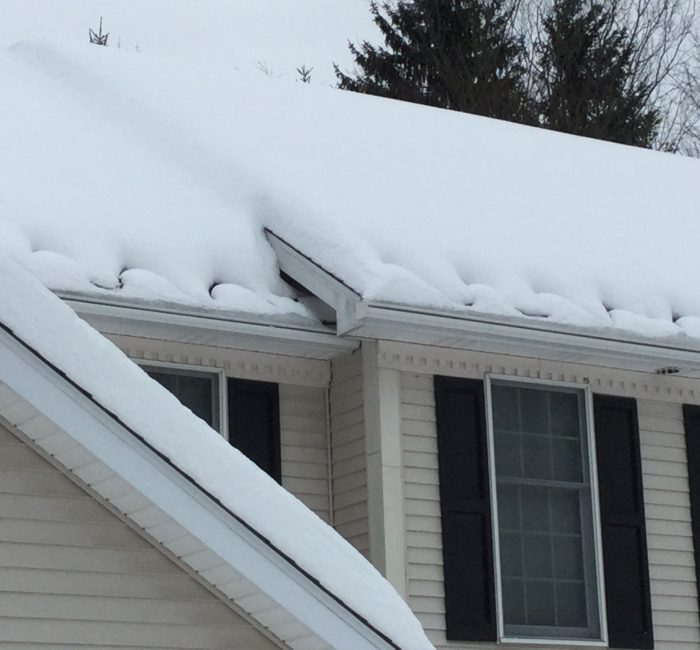 Heat Cables on a roof full of snow. Making sure that there aren't large icicles damaging your gutter's