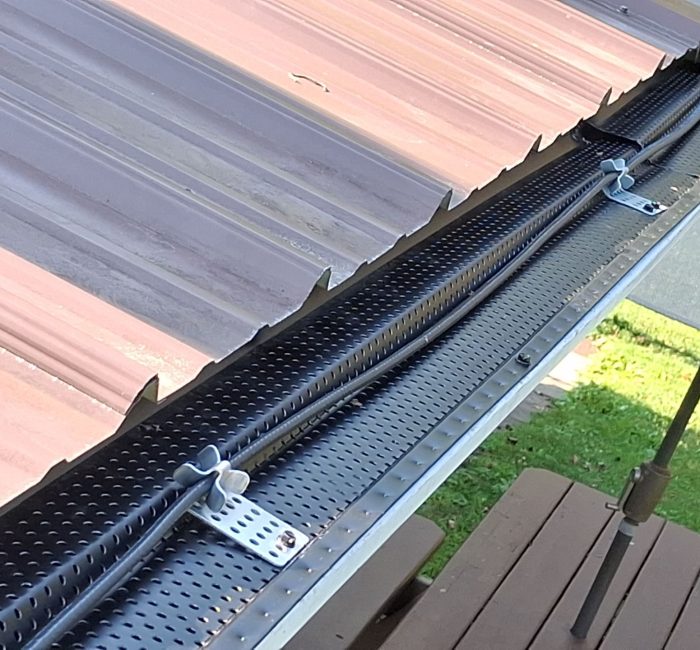 Metal roof with gutter guard and heat cables installed by Gutter Solutions of Lake Erie