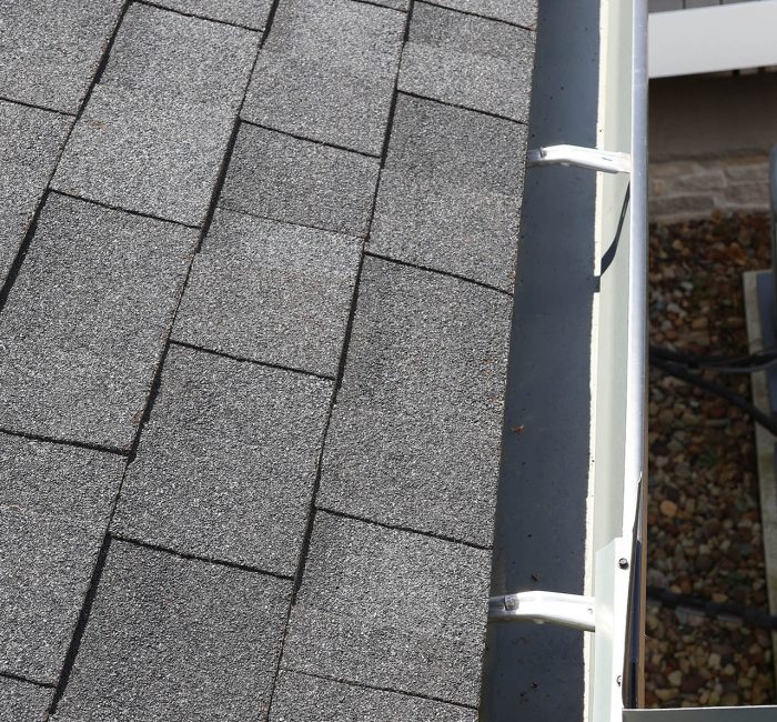 Gutters on a rood with asphalt shingles installed by Gutter Solutions of Lake Erie