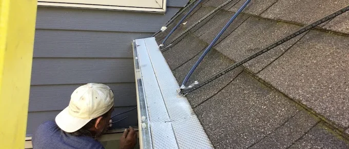 Heat Cables on roof with worker