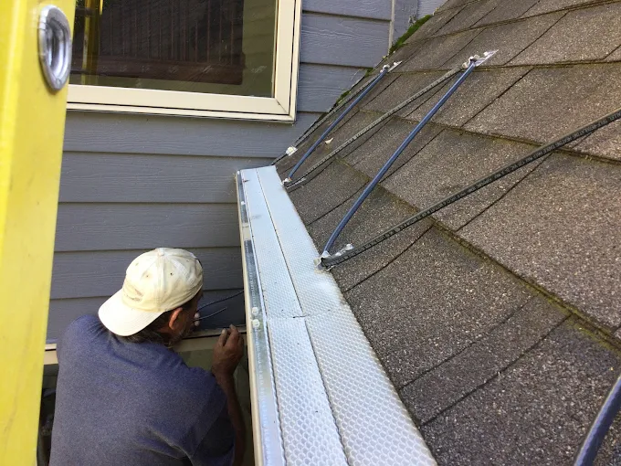 Heat Cables on roof with worker